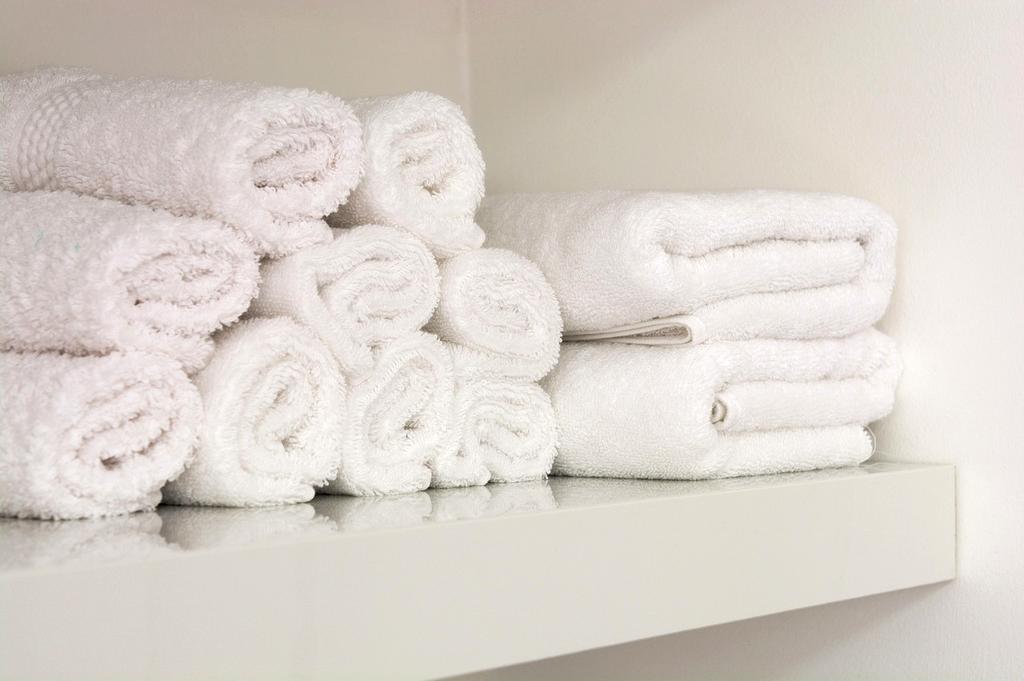 Compact bathroom vanity with under-sink organizers and cleaning products