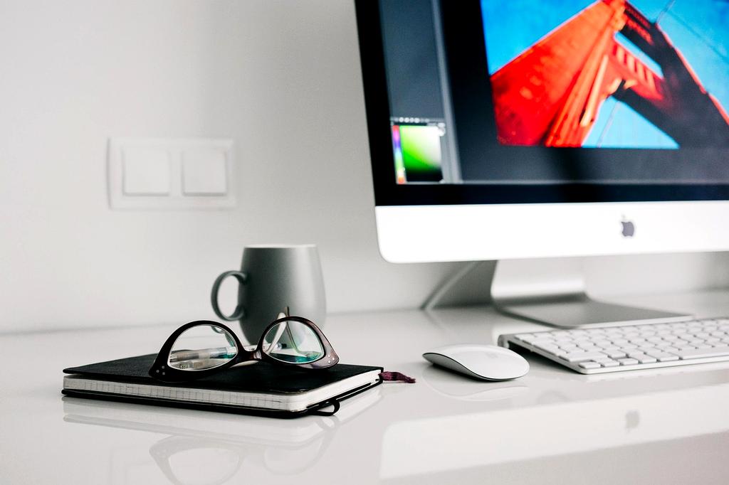 Organized home office desk with filing system and clean workspace
