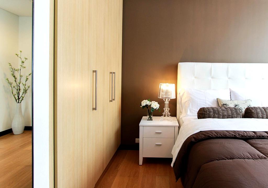 Neatly arranged minimalist bedroom closet with shoes and clothes