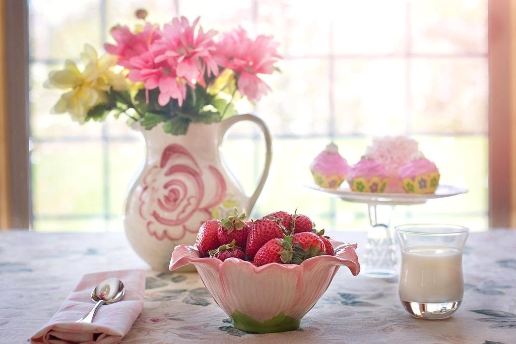 Organized breakfast table with coffee, fruits and planner