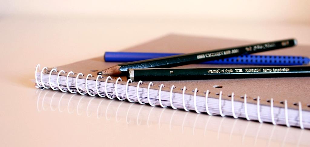 Organized office supplies including pens, notebooks, and files arranged neatly
