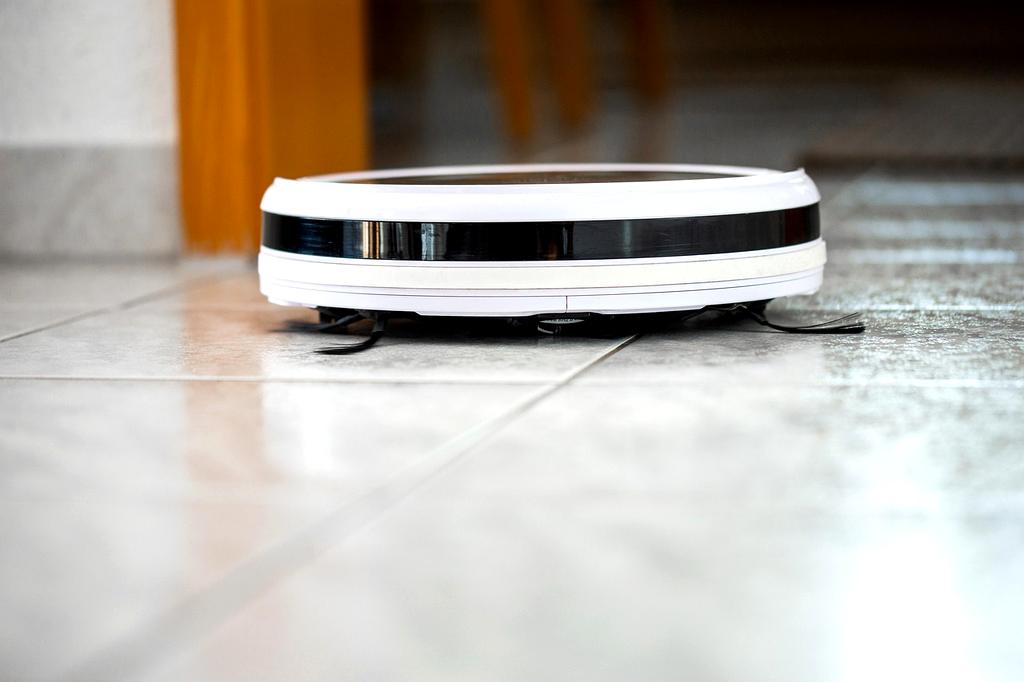 Robotic vacuum cleaner navigating through organized living room