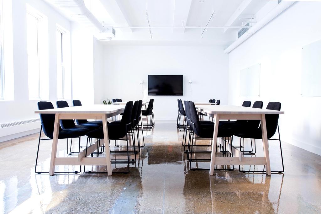 Focused person organizing workspace with notebook and supplies